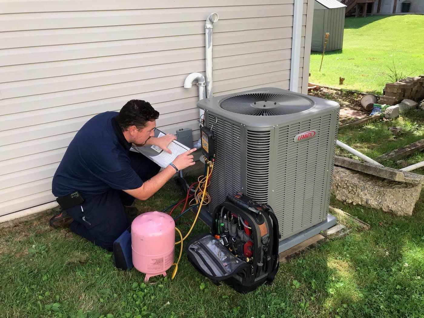 An outdoor air conditioning condenser unit beside a home.