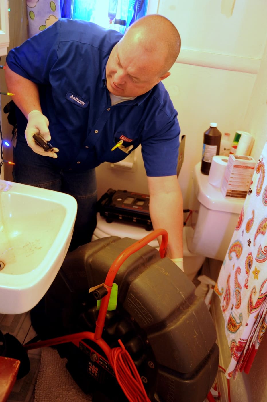 A plumber working on a drain.